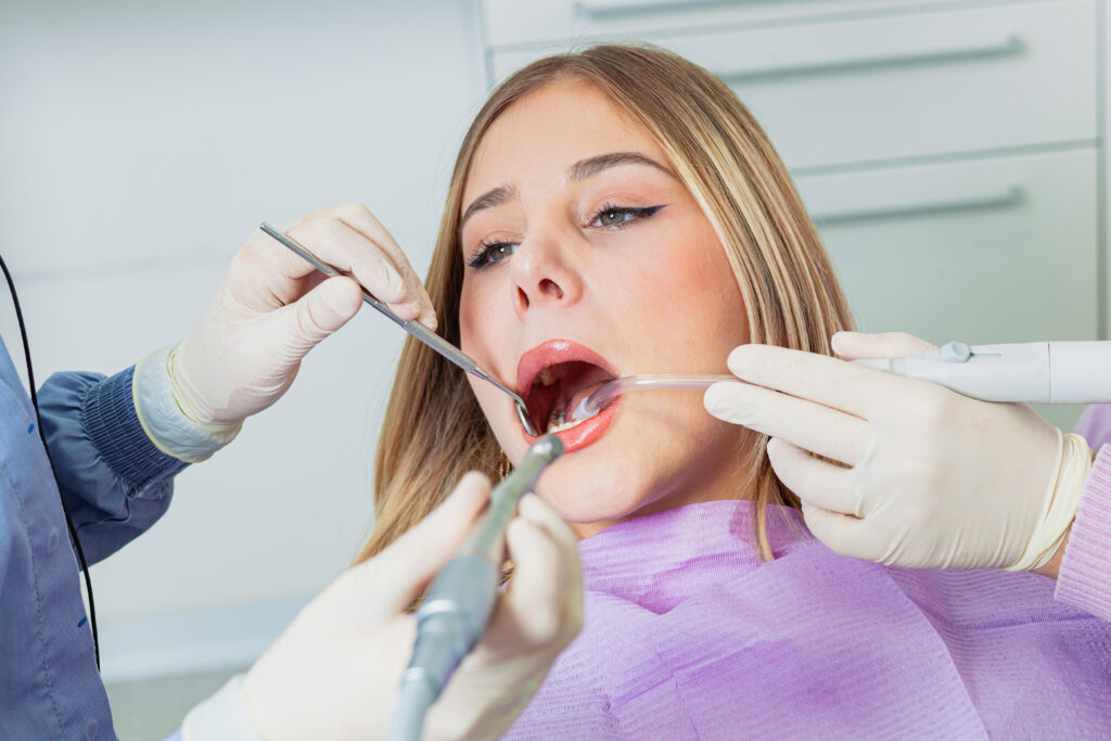 dentist performing dental check up on young woman 2026 01 09 09 58 00 utc