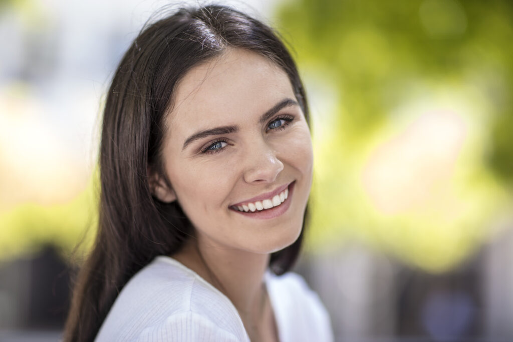 portrait of young woman outdoors smiling 2026 01 09 10 19 54 utc